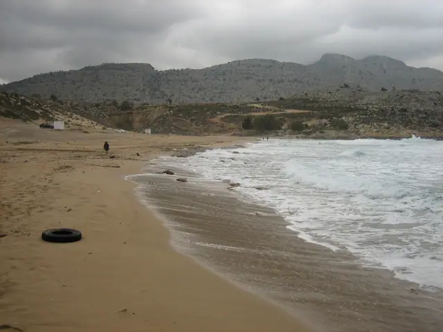 Agathi Beach in Rhodes, featuring a sandy shoreline with moderate water conditions