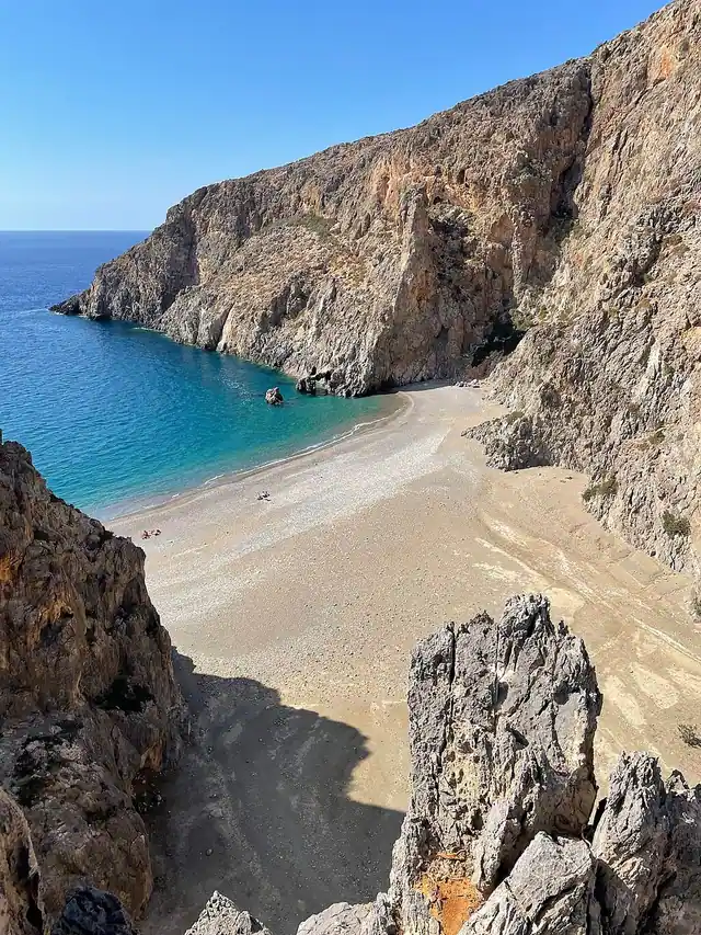 Agiofaraggo Beach in Crete, featuring a mixed shoreline with calm water conditions