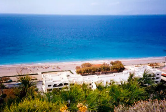 Paralia Ixias beach in Rhodes, featuring a pebbly shoreline with moderate water conditions