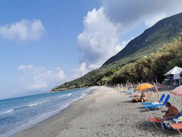 Paramonas Beach in Corfu, featuring a pebbly shoreline with moderate water conditions