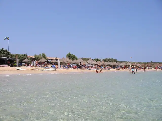 Santa Maria Beach in Paros, featuring a sandy shoreline with calm water conditions