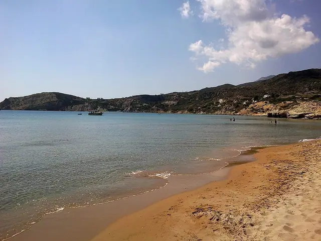Provatas Beach in Milos, featuring a sandy shoreline with calm water conditions