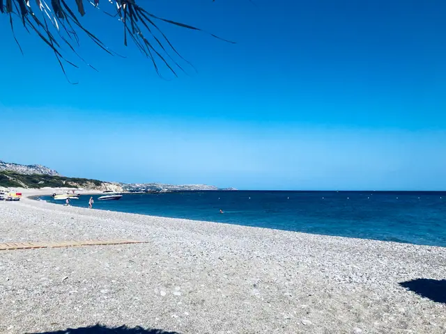 Kokkinogia Beach in Rhodes, featuring a sandy shoreline with moderate water conditions