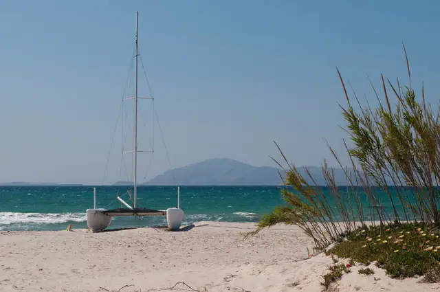 Mastichari Bay beach in Kos, featuring a sandy shoreline with moderate water conditions, certified with Blue Flag status for environmental quality