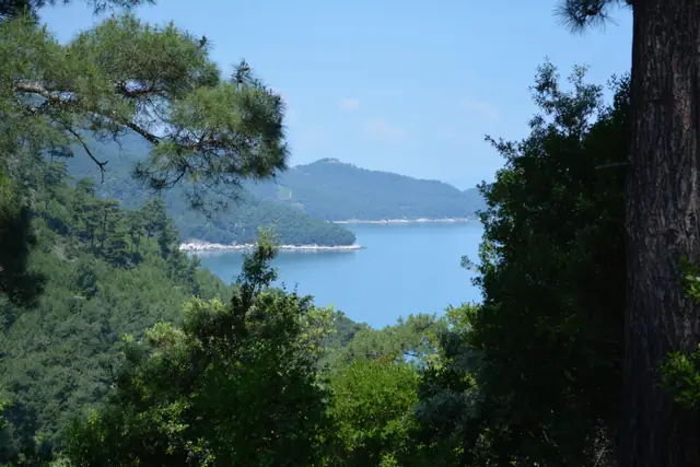 Vathi beach in Thassos, featuring a sandy shoreline with moderate water conditions
