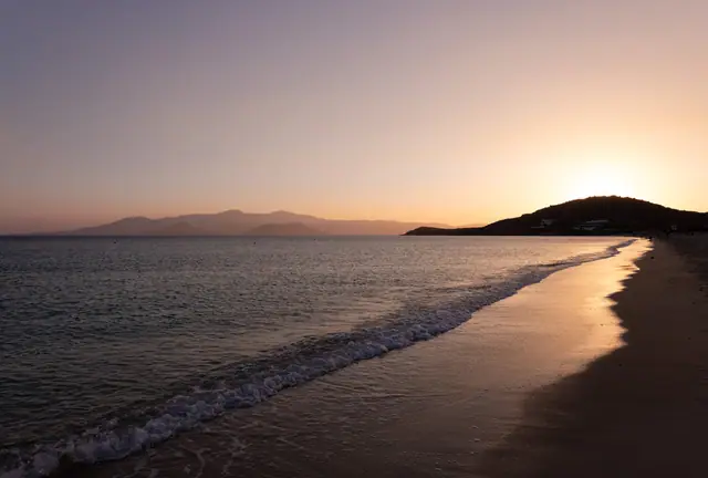 Agios Prokopios beach in Naxos, featuring a sandy shoreline with calm water conditions