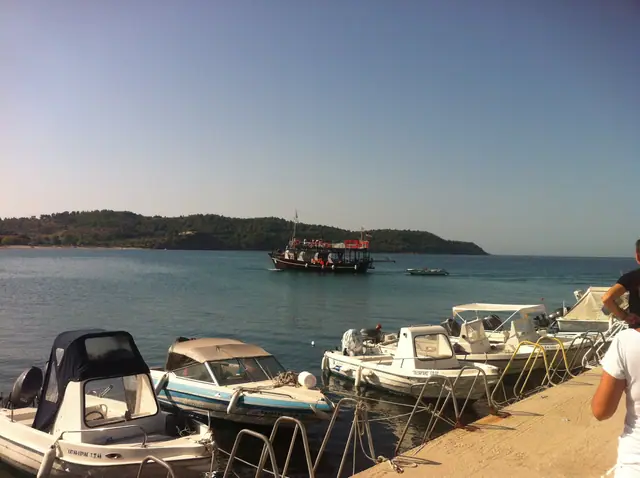 Potos beach in Thassos, featuring a sandy shoreline with moderate water conditions