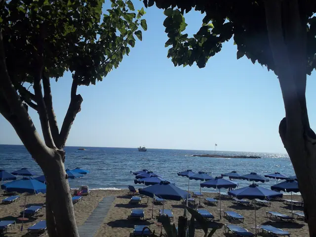 Faliraki A beach in Rhodes, featuring a sandy shoreline with moderate water conditions