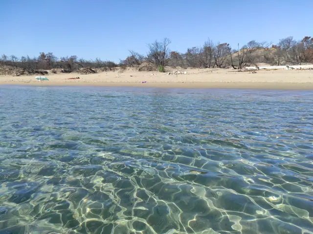 Glystra Beach in Rhodes, featuring a sandy shoreline with moderate water conditions