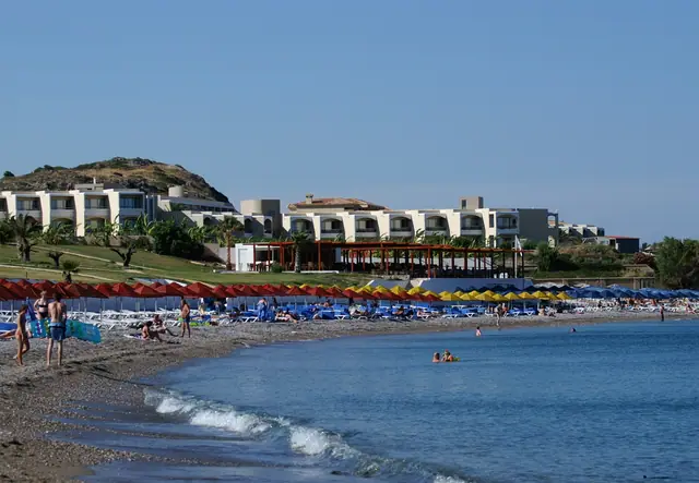 Kolymbia Beach in Rhodes, featuring a sandy shoreline with moderate water conditions