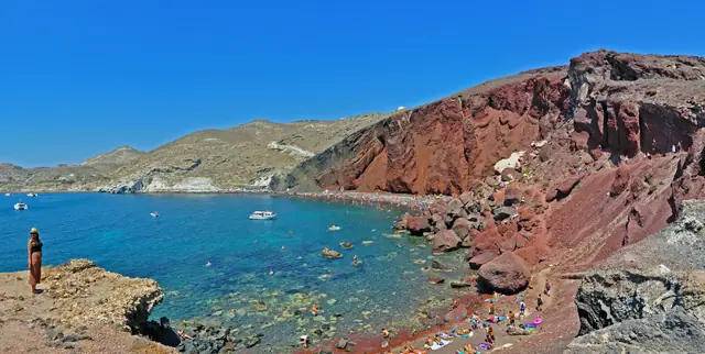 Red Beach in Santorini, featuring a sandy shoreline with calm water conditions