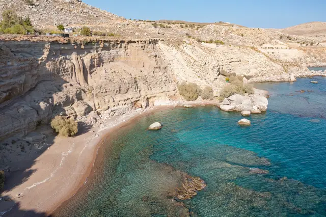 Kokkini Ammos (Red Sand) Beach in Rhodes, featuring a sandy shoreline with moderate water conditions