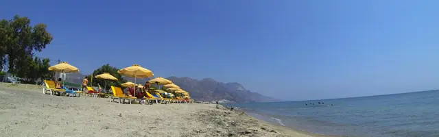 Malibu Beach in Kos, featuring a sandy shoreline with calm water conditions