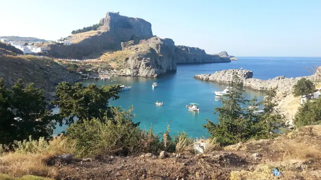 St. Paul's Beach in Rhodes, featuring a sandy shoreline with calm water conditions