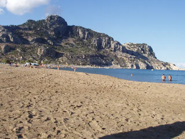 Tsampika beach in Rhodes, featuring a sandy shoreline with moderate water conditions