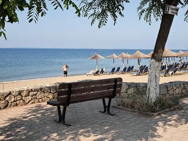 Psakoudia Beach in Chalkidiki, featuring a sandy shoreline with calm water conditions, certified with Blue Flag status for environmental quality