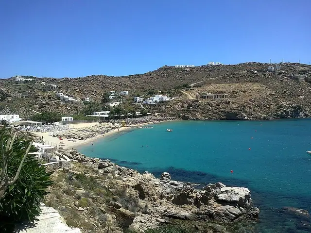 Super Paradise Beach in Mykonos, featuring a sandy shoreline with calm water conditions