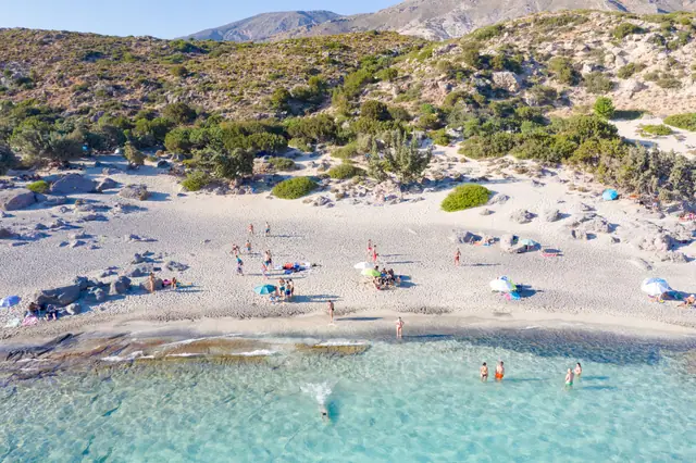 Kedrodasos Beach in Crete, featuring a sandy shoreline with calm water conditions