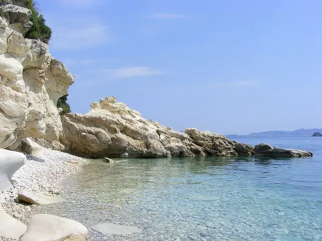 Marathias Beach in Zakynthos, featuring a pebbly shoreline with calm water conditions
