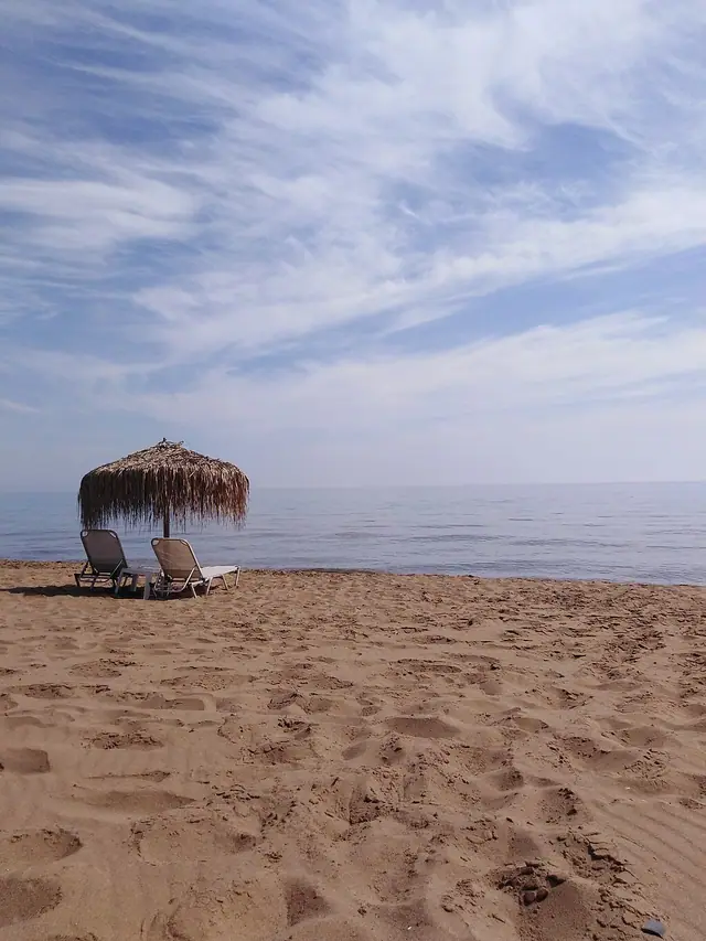 Gardeno Beach in Corfu, featuring a sandy shoreline with calm water conditions