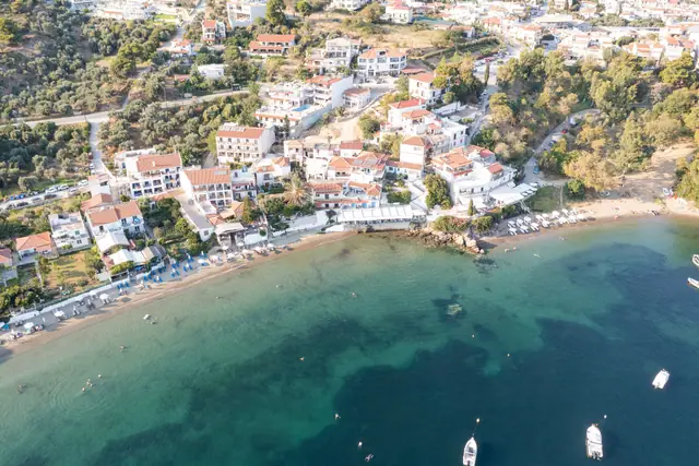 Megali Ammos beach in Skiathos, featuring a sandy shoreline with moderate water conditions