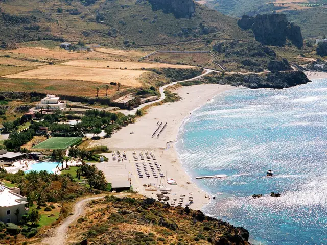 Damnoni Beach in Crete, featuring a sandy shoreline with calm water conditions