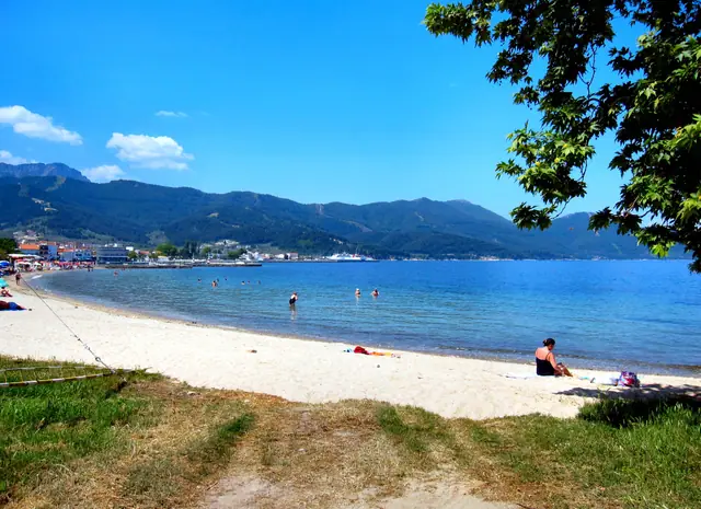 Karnagio beach in Thassos, featuring a sandy shoreline with moderate water conditions