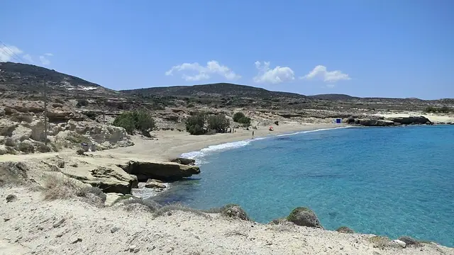 Alogomandra Beach in Milos, featuring a sandy shoreline with moderate water conditions