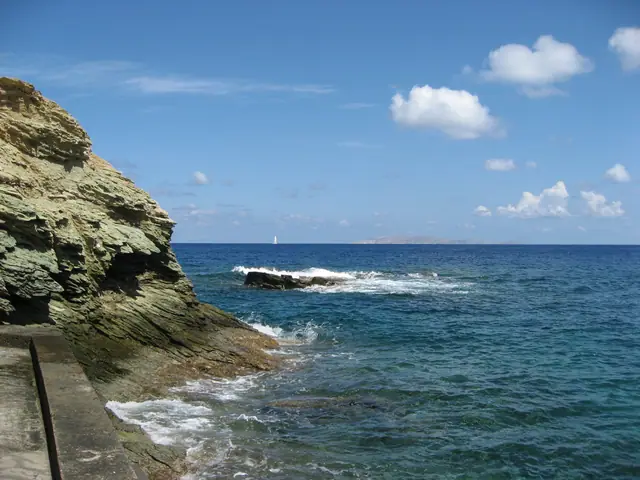 Agia Pelagia Beach in Crete, featuring a sandy shoreline with calm water conditions