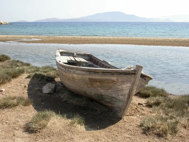 Kalantos Beach in Naxos, featuring a sandy shoreline with calm water conditions