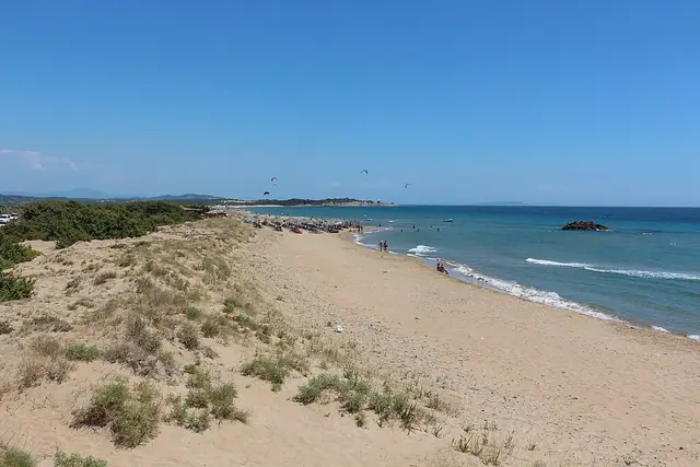 Chalikounas Beach in Corfu, featuring a sandy shoreline with moderate water conditions