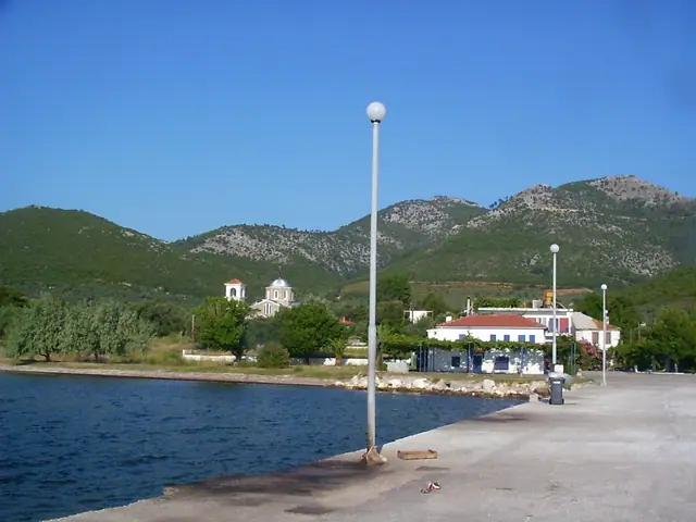Skala Rachoni beach in Thassos, featuring a sandy shoreline with moderate water conditions