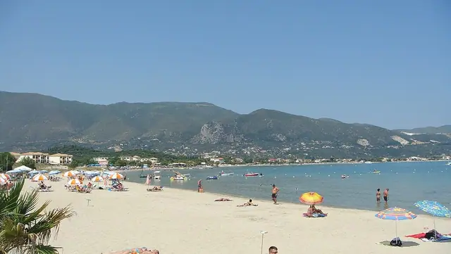 Alykes Beach in Zakynthos, featuring a mixed shoreline with calm water conditions, certified with Blue Flag status for environmental quality
