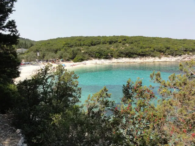 Emplisi Beach in Kefalonia, featuring a pebbly shoreline with calm water conditions