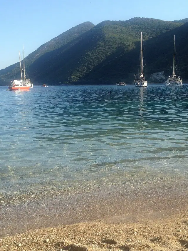 Desimi Beach in Lefkada, featuring a mixed shoreline with calm water conditions