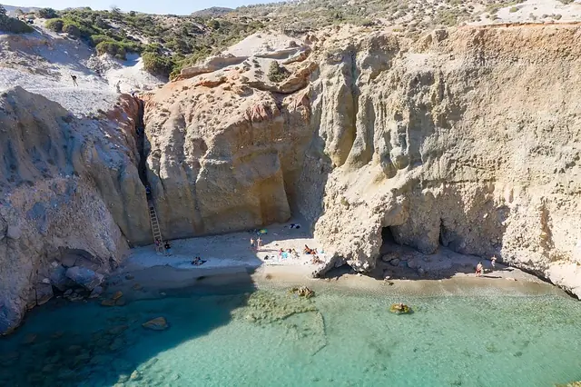 Tsigrado Beach in Milos, featuring a mixed shoreline with calm water conditions
