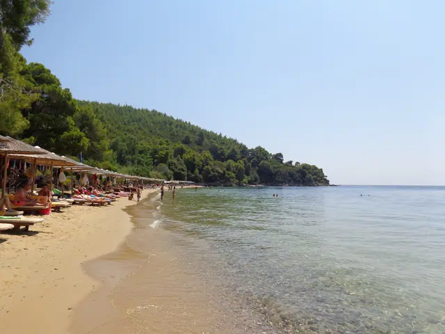 Maratha Beach in Skiathos, featuring a sandy shoreline with moderate water conditions