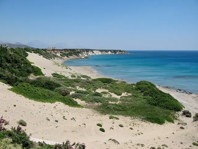 Orthi Ammos Beach in Crete, featuring a mixed shoreline with calm water conditions