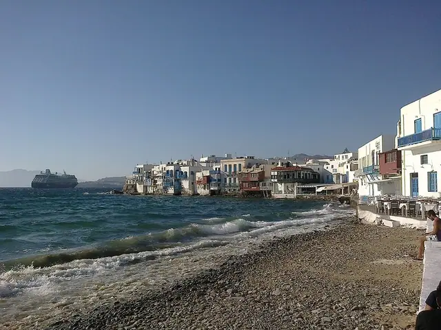 Chora Beach in Mykonos, featuring a mixed shoreline with calm water conditions