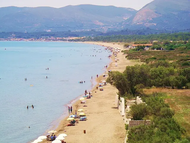 Kalamaki Beach in Zakynthos, featuring a sandy shoreline with calm water conditions