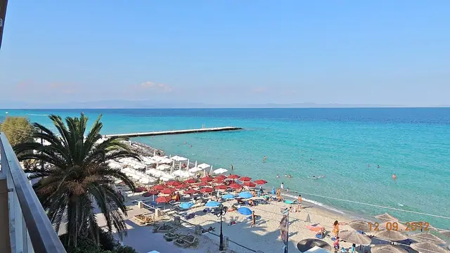 Kalithea Beach in Chalkidiki, featuring a mixed shoreline with calm water conditions