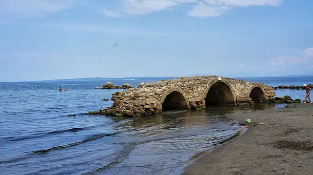 Argassi Beach in Zakynthos, featuring a sandy shoreline with calm water conditions