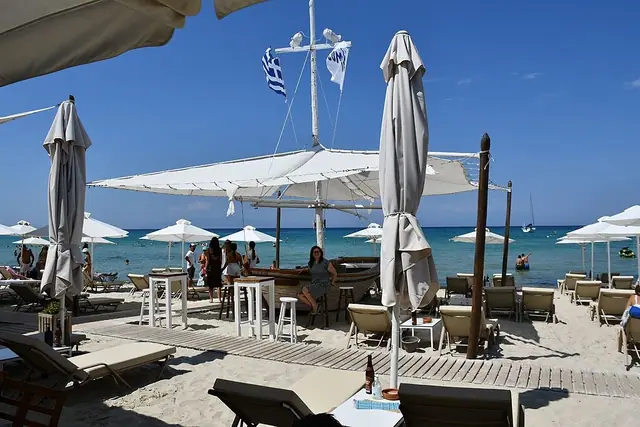 Sani Beach in Chalkidiki, featuring a sandy shoreline with calm water conditions