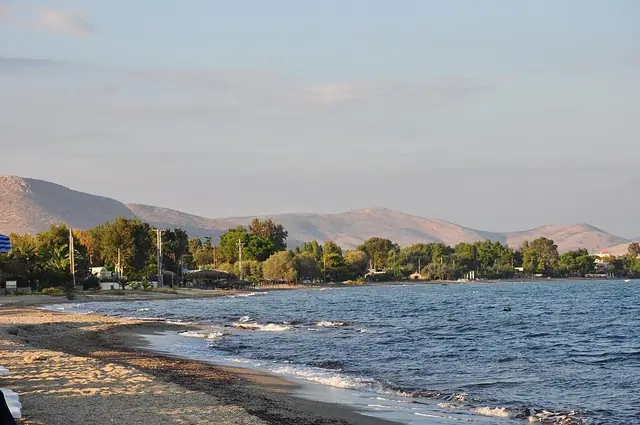 Marathon Beach in Attica, featuring a sandy shoreline with calm water conditions