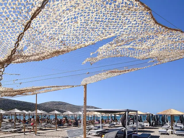 Anavissos Beach in Attica, featuring a sandy shoreline with calm water conditions