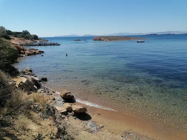 Kavouri Beach in Attica, featuring a sandy shoreline with calm water conditions