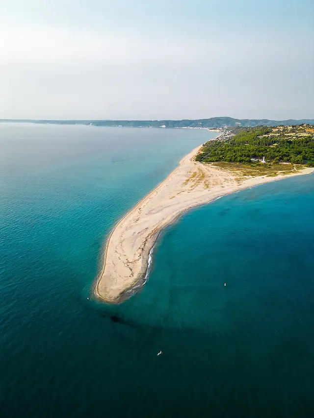 Possidi Beach in Chalkidiki, featuring a sandy shoreline with calm water conditions