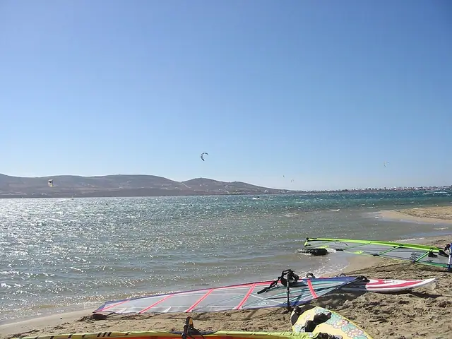 Pounta Beach in Paros, featuring a sandy shoreline with wavy water conditions