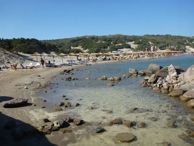 Paradise Beach in Kos, featuring a sandy shoreline with moderate water conditions