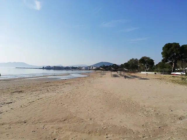 Artemida Beach in Attica, featuring a sandy shoreline with calm water conditions
